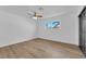 Bedroom with wood-look flooring, ceiling fan, and window offering plenty of natural light at 3228 Robin Cir, Las Vegas, NV 89121