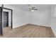 Bedroom featuring wood-look flooring, a ceiling fan, and a door to other rooms at 3228 Robin Cir, Las Vegas, NV 89121