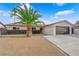 Inviting single-story home boasts a new driveway, a dark accent brick wall, and a beautiful mature palm tree at 3228 Robin Cir, Las Vegas, NV 89121