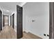 Hallway with wood-look flooring leading to bedrooms and laundry area with washer dryer hookups at 3228 Robin Cir, Las Vegas, NV 89121