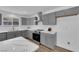 Modern kitchen with grey cabinets, stylish countertops, and stainless steel appliances at 3228 Robin Cir, Las Vegas, NV 89121