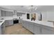 Modern kitchen with a marble island, stainless steel appliances, and grey cabinetry at 3228 Robin Cir, Las Vegas, NV 89121