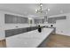Bright kitchen with stainless steel appliances, a large island, and modern lighting at 3228 Robin Cir, Las Vegas, NV 89121