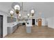 Stylish kitchen featuring grey cabinetry, a marble island, and modern lighting fixtures at 3228 Robin Cir, Las Vegas, NV 89121