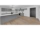 Bright kitchen with gray cabinets, white countertops, backsplash, stainless steel appliances, and wood-look flooring at 3228 Robin Cir, Las Vegas, NV 89121