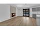 Spacious living area features a modern fireplace and French doors, all complemented by new light wood flooring at 3228 Robin Cir, Las Vegas, NV 89121