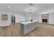 Spacious living room with a fireplace, wood-look flooring, and island with white countertop at 3228 Robin Cir, Las Vegas, NV 89121