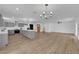 Open-concept living space with luxury vinyl floors and grey kitchen with marble countertops at 3228 Robin Cir, Las Vegas, NV 89121