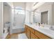 Bathroom featuring dual sinks, a soaking tub, and bright, clean finishes at 3405 Robust Robin Pl # 3, North Las Vegas, NV 89084