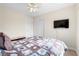 Comfortable bedroom featuring a ceiling fan, TV, and neutral walls, providing a relaxing atmosphere at 3405 Robust Robin Pl # 3, North Las Vegas, NV 89084