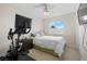 Cozy bedroom features an exercise bike, bright natural light, and soft carpet at 3405 Robust Robin Pl # 3, North Las Vegas, NV 89084