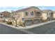 Inviting townhome featuring an attached three-car garage and classic desert landscaping at 3405 Robust Robin Pl # 3, North Las Vegas, NV 89084