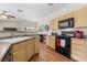 Bright kitchen features wood cabinets, granite countertops, and modern appliances at 3405 Robust Robin Pl # 3, North Las Vegas, NV 89084