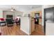 Open-concept living area with modern appliances, wood floors and adjoining kitchen at 3405 Robust Robin Pl # 3, North Las Vegas, NV 89084