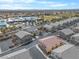 Aerial view of grey two-story houses with desert landscaping, surrounded by schools and neighborhood streets at 3405 Robust Robin Pl # 3, North Las Vegas, NV 89084
