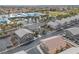 Aerial view of grey two-story houses with desert landscaping, surrounded by schools and neighborhood streets at 3405 Robust Robin Pl # 3, North Las Vegas, NV 89084
