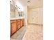 Bathroom featuring double sinks, cabinets, large mirror and tile flooring at 346 Andy Wheeler Dr, Henderson, NV 89011