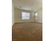 Large bedroom with a window providing great natural light and plush carpet flooring at 346 Andy Wheeler Dr, Henderson, NV 89011