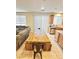 Open-concept dining area featuring a large wooden table and seating, seamlessly connected to the kitchen at 346 Andy Wheeler Dr, Henderson, NV 89011