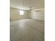 Spacious, empty garage with concrete floors and a white garage door at 346 Andy Wheeler Dr, Henderson, NV 89011