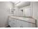 Modern bathroom with double sinks, granite countertop, and white cabinets at 4040 Beech Fern Ave, North Las Vegas, NV 89084