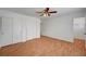 Bedroom with wood-look floors, ceiling fan, and access to the walk-in closet at 4224 Glisan Ct, Las Vegas, NV 89129