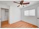 This bedroom offers natural light, wood-look floors, and a ceiling fan at 4224 Glisan Ct, Las Vegas, NV 89129