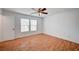 Bright bedroom with wood-look floors, ceiling fan, and double windows at 4224 Glisan Ct, Las Vegas, NV 89129