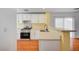 Bright kitchen with white cabinets, modern appliances, and beautiful backsplash at 4224 Glisan Ct, Las Vegas, NV 89129