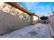 Backyard with a concrete patio, a gas meter, and an umbrella covered table and chairs at 4363 Del Santos Dr, Las Vegas, NV 89121