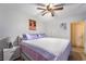 Bright bedroom featuring a ceiling fan, complemented by soft purple accents and natural lighting at 4363 Del Santos Dr, Las Vegas, NV 89121