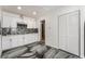 Modern kitchen with white cabinetry, stainless steel microwave, and unique backsplash design at 4363 Del Santos Dr, Las Vegas, NV 89121