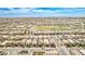 Expansive aerial view of a vibrant community featuring well-maintained homes and green spaces against a backdrop of distant mountains at 4423 Creekside Cavern Ave, North Las Vegas, NV 89084