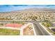 This aerial view showcases a neighborhood with modern homes, a community park, and scenic mountain backdrop at 4423 Creekside Cavern Ave, North Las Vegas, NV 89084