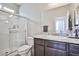 Clean bathroom featuring a shower, granite countertop vanity, and a large mirror at 4423 Creekside Cavern Ave, North Las Vegas, NV 89084