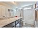 Bathroom featuring granite countertops, dark cabinets, and a shower-tub combination at 4423 Creekside Cavern Ave, North Las Vegas, NV 89084