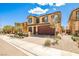 Lovely two-story home featuring a brick driveway, a two-car garage, and low-maintenance landscaping at 4423 Creekside Cavern Ave, North Las Vegas, NV 89084