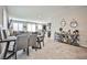 Open-concept living space with tile floors, a dining table, and views of the kitchen and seating area at 4423 Creekside Cavern Ave, North Las Vegas, NV 89084