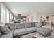 Bright living room with tile floors, comfortable sectional sofa, and an open view to the kitchen at 4423 Creekside Cavern Ave, North Las Vegas, NV 89084