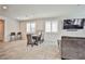 Cozy living area with tile floors, a dining table, a modern TV, and comfortable seating at 4423 Creekside Cavern Ave, North Las Vegas, NV 89084