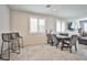 Comfortable living space with tile floors, a dining table, bar stools, and a modern television at 4423 Creekside Cavern Ave, North Las Vegas, NV 89084