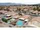 Wide aerial view shows neighborhood featuring outdoor pool and spas at 4611 Julesburg Dr, Las Vegas, NV 89139