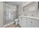 Stylish bathroom features a glass shower, marble-like tile, a white vanity, and modern fixtures at 4611 Julesburg Dr, Las Vegas, NV 89139