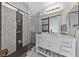 Elegant bathroom with walk-in shower, marbled tile, and a farmhouse sink at 4611 Julesburg Dr, Las Vegas, NV 89139