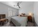 Cozy bedroom featuring a ceiling fan, shuttered window, and a comfortable bed with patterned pillows at 4611 Julesburg Dr, Las Vegas, NV 89139