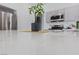 Close-up view of a gleaming white countertop with a modern plant as a centerpiece in the kitchen at 4611 Julesburg Dr, Las Vegas, NV 89139