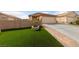 Well-maintained front yard with artificial grass, brick-paved driveway and walkway leading to a two-car garage at 4611 Julesburg Dr, Las Vegas, NV 89139