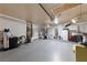 Spacious garage with epoxy flooring, storage racks, and plenty of room for vehicles and projects at 4611 Julesburg Dr, Las Vegas, NV 89139