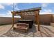 Backyard featuring a hot tub with a wooden pergola, and paved patio for entertaining at 4611 Julesburg Dr, Las Vegas, NV 89139