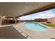 Backyard with a swimming pool, a covered patio, and ample space for outdoor entertainment at 4611 Julesburg Dr, Las Vegas, NV 89139